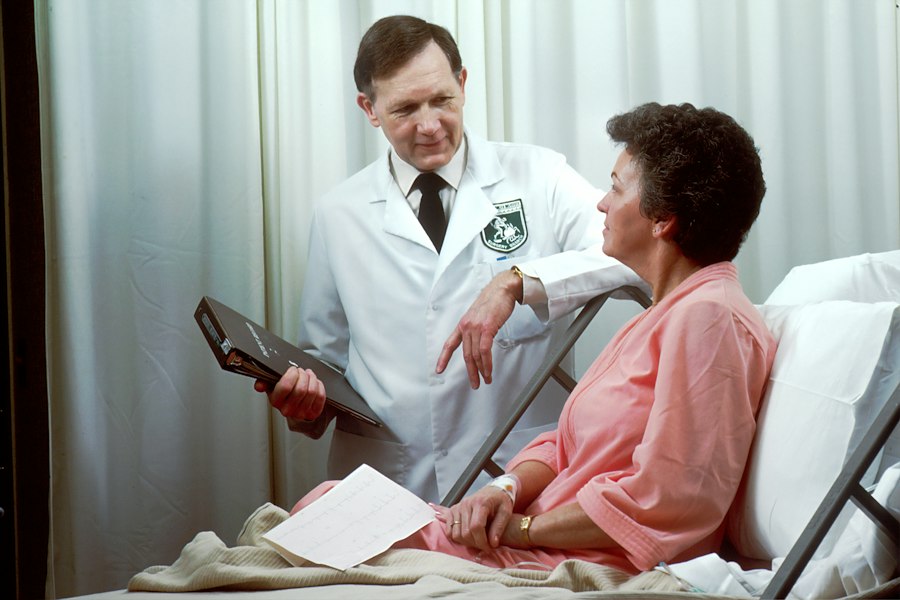 Doctor talking to a patient in a hospital bed